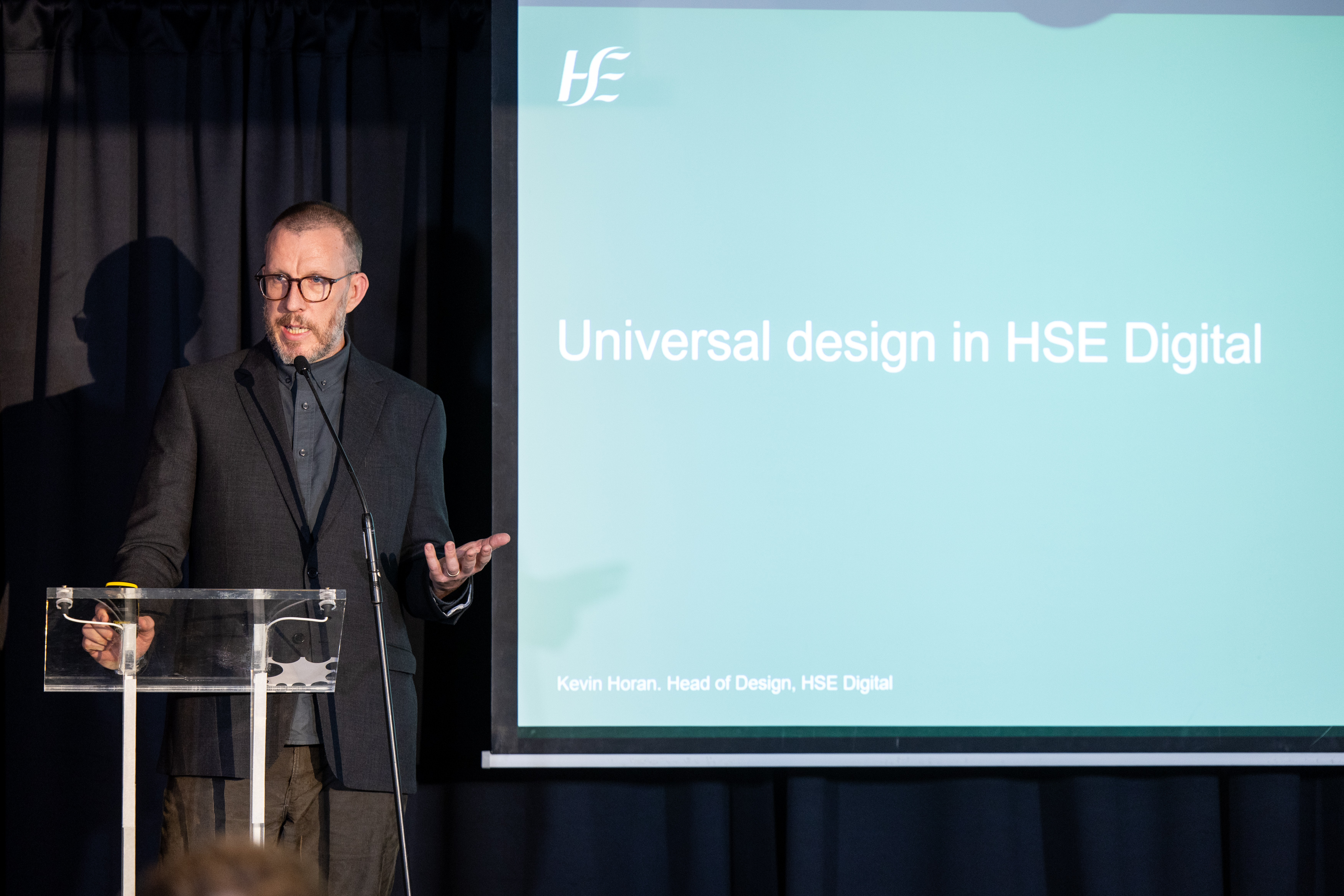 Kevin Horan gestures as he speaks on stage