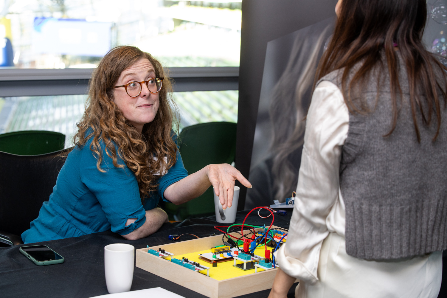 Dr. Tara Flynn showing a guest her project